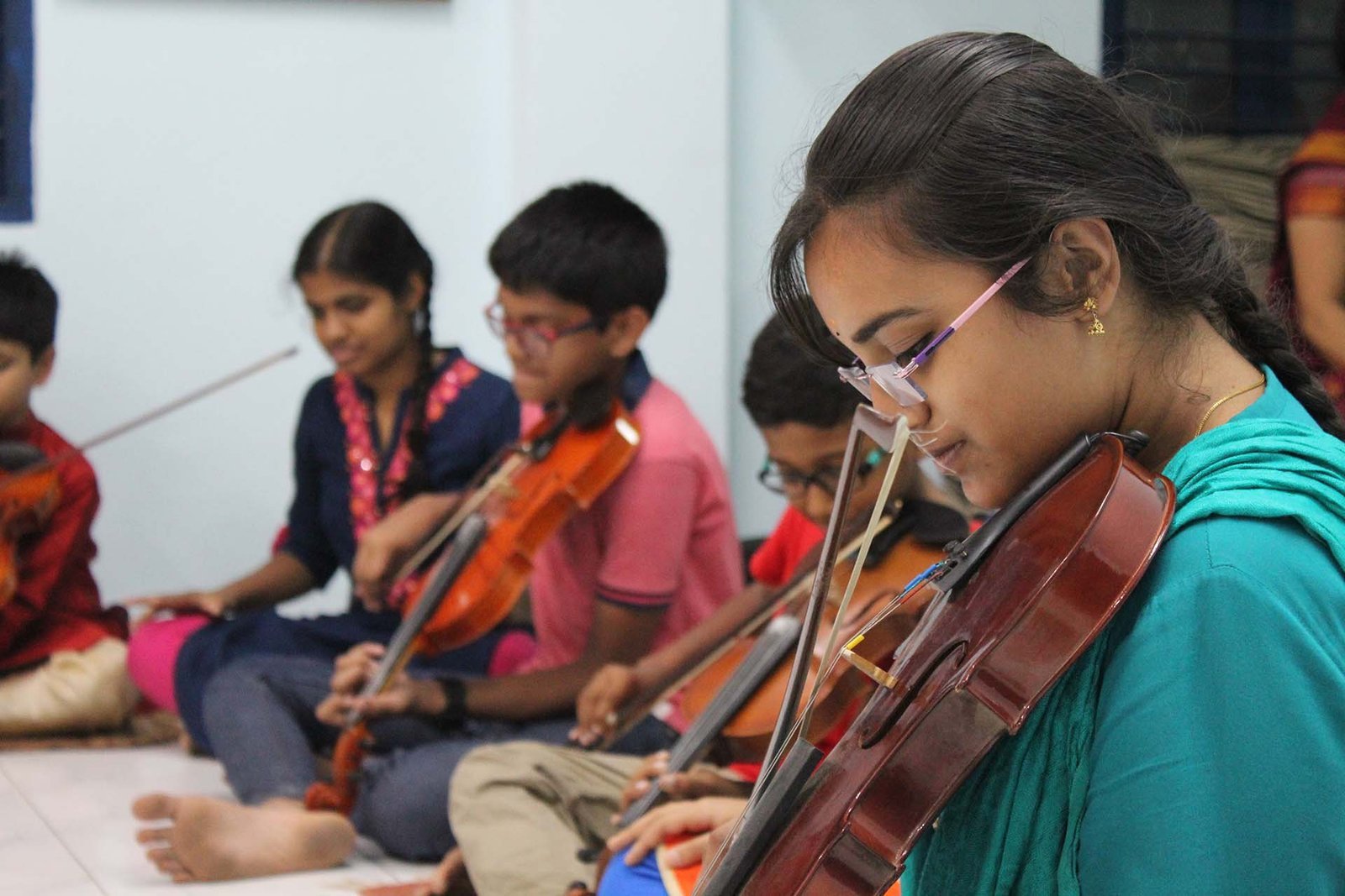 Gurukulam students practicing violin together
